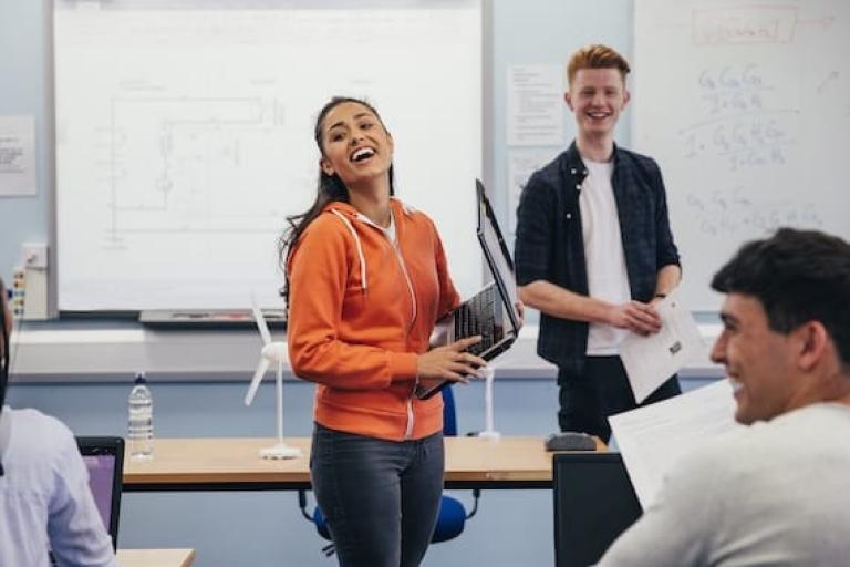 female student laughing with other students