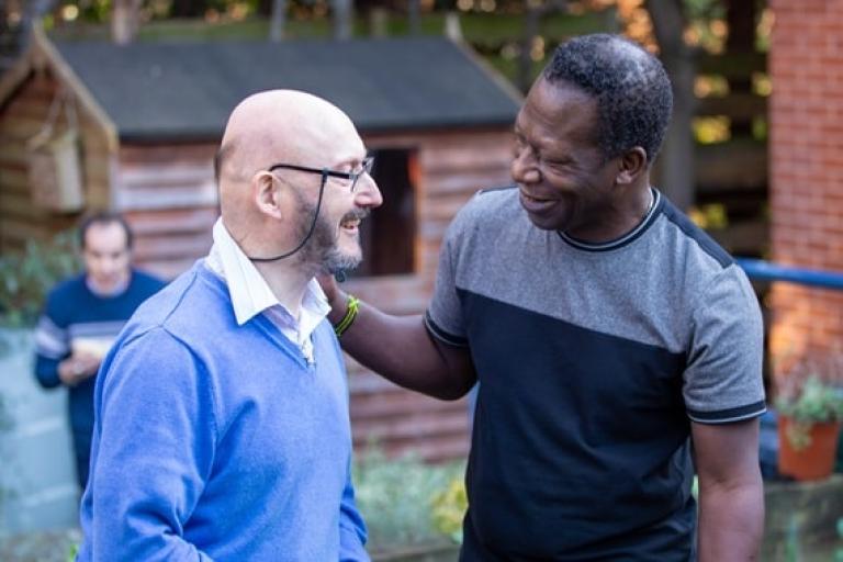 Two men standing in a garden