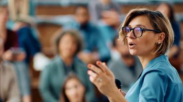 Woman lecturing class of students