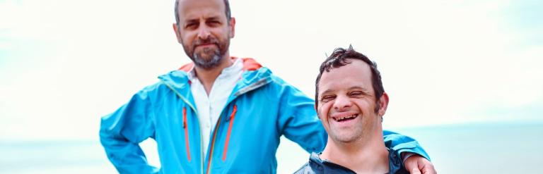 man with his arm on shoulder of younger man