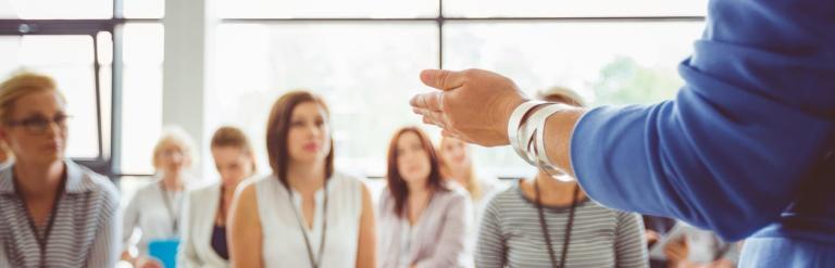 hands of person lecturing class of people